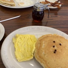 Chocolate chip pancakes, eggs, banana pancake, bacon