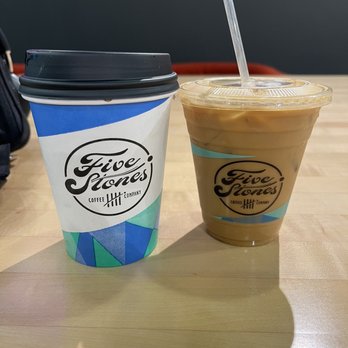 Five Stones Coffee Company - 12 oz Americano (left) and 12 oz Iced Latte w/ almond mill (right) - Coffee & Tea Near Me - Kirkland, Washington Five Stones Coffee Company - 12 oz Americano (left) and 12 oz Iced Latte w/ almond mill (right) - Coffee & Tea Near Me - Kirkland, Washington