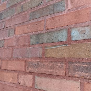 Fahey Exteriors - Brick face damaged by blades - Roofing Near Me