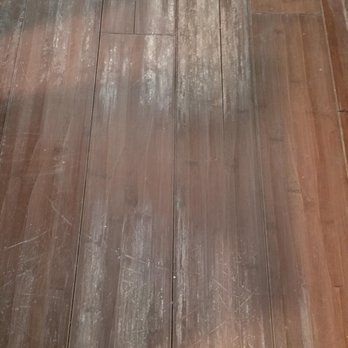 Open Book Hardwood Floors - cracks and water damage. peeling finish - Flooring Near Me
