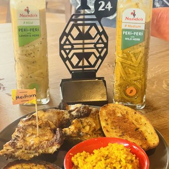 Nando's Peri-Peri - Mild 1/4 leg quarter with garlic bread and Portuguese Rice - Chicken Shop Near Me - Virginia Beach, Virginia Nando's Peri-Peri - Mild 1/4 leg quarter with garlic bread and Portuguese Rice - Chicken Shop Near Me - Virginia Beach, Virginia
