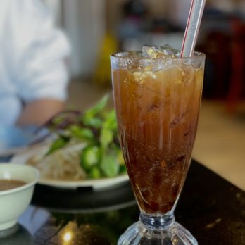 Pho Van - a glass of iced tea with a straw and a spoon - Vietnamese Near Me - San Diego, California Pho Van - a glass of iced tea with a straw and a spoon - Vietnamese Near Me - San Diego, California