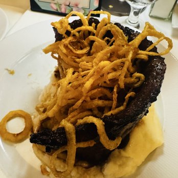 Jake's Steakhouse - Marinated scrap steak was cooked to request, served on mashed potatoes, with tasty onion rings on top. Highly recommend this! - Steakhouses Near Me - East Meadow, New York
