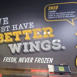 a sign that says we just have better wings fresh, never frozen
