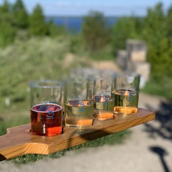 Suttons Bay Ciders - four glasses of cid on a wooden tray - Breweries Near Me - Suttons Bay, Michigan Suttons Bay Ciders - four glasses of cid on a wooden tray - Breweries Near Me - Suttons Bay, Michigan