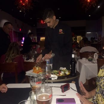 Sancho Restaurant - Distributing the paella - Spanish Near Me - Miami, Florida