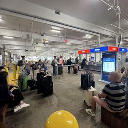 Over 60 people waiting around for cars since they overbooked their cars. Over 60 people waiting around for cars since they overbooked their cars.