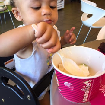 Menchie's - a baby eating a bowl of food - Ice Cream & Frozen Yogurt Near Me - Clackamas, Oregon