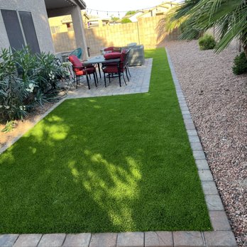Green Tier Landscape - a patio with a table and chairs - Landscaping Near Me