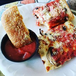 Pizza Hut - Detroit Pizza and a half eaten bread stick.