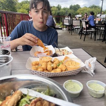 Tap Station - Kiddo is eating pimento cheese egg rolls and tater tots with beer cheese on the side. - Breweries Near Me - Apex, North Carolina Tap Station - Kiddo is eating pimento cheese egg rolls and tater tots with beer cheese on the side. - Breweries Near Me - Apex, North Carolina