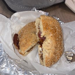 Sesame bagel with cream cheese and bacon Sesame bagel with cream cheese and bacon