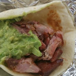 a burrito with guacamole a burrito with guacamole