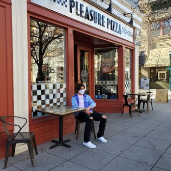Pleasure Pizza - a woman sitting on a bench in front of a restaurant - Pizza Near Me - Santa Cruz, California Pleasure Pizza - a woman sitting on a bench in front of a restaurant - Pizza Near Me - Santa Cruz, California