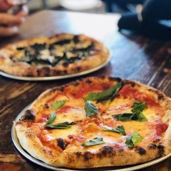 Cafe Crema - two pizzas on plates on a table - Coffee & Tea Near Me - West Vancouver, British Columbia Cafe Crema - two pizzas on plates on a table - Coffee & Tea Near Me - West Vancouver, British Columbia