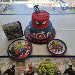 a table with a birthday cake and decorations