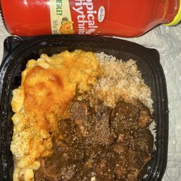 Delicious oxtails with creamy mac & cheese and white rice. Washing down with a sweet tropical rhythm fruit punch. Get it.