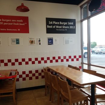 Five Guys - a table and chairs in a restaurant - Fast Food Near Me - Harrisburg, Pennsylvania