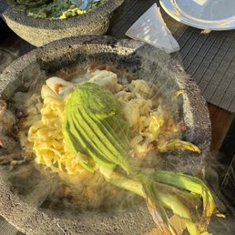 Mocajete with steak and shrimp, that cheese under the avocado will soon be melted Mocajete with steak and shrimp, that cheese under the avocado will soon be melted