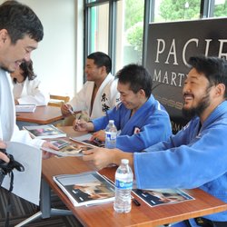 Pacific Rim Martial Arts Academy - Mr. Kosuke Tanaka (All Japan Champion) signing an autograph for Mr. Nathan Pham...one of our judo instructors.