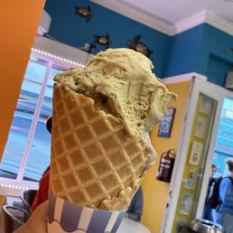 One huge scoop of gelato inside waffle cone One huge scoop of gelato inside waffle cone