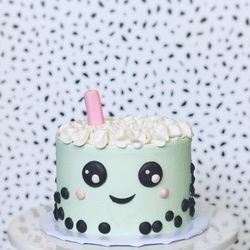 Bakes by Eileen - Cereal Milk Celebration Cake (small) with boba character design. Chocolate detailing + fondant straw.