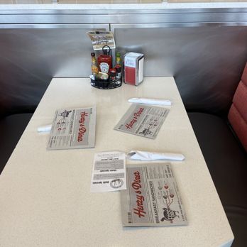 Henry's Diner - a table with menus on it - Diners Near Me - Piscataway Township, New Jersey