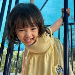 Little Builders International Academy - Toddler enjoying active outdoor play and exploration.