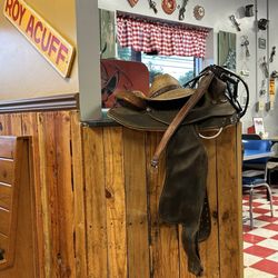 Ruth’s Kitchen - An old saddle and cowboy hat next to my table.