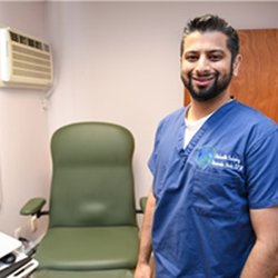 Davinder Bhela, DPM - Davinder Bhela, DPM in an exam room at Hicksville Podiatry