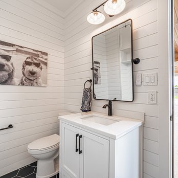 Luxe Outdoors - a white bathroom with a black and white picture on the wall - General Contractors Near Me - Cypress, Texas Luxe Outdoors - a white bathroom with a black and white picture on the wall - General Contractors Near Me - Cypress, Texas