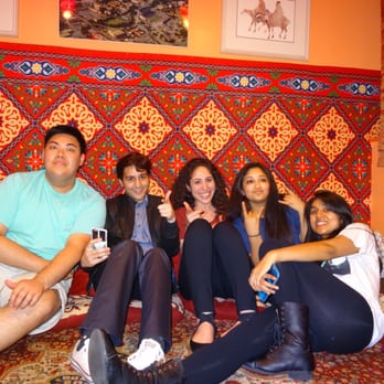 Yahala Hookah Lounge - a group of people sitting on a bed - Hookah Bars Near Me - Austin, Texas