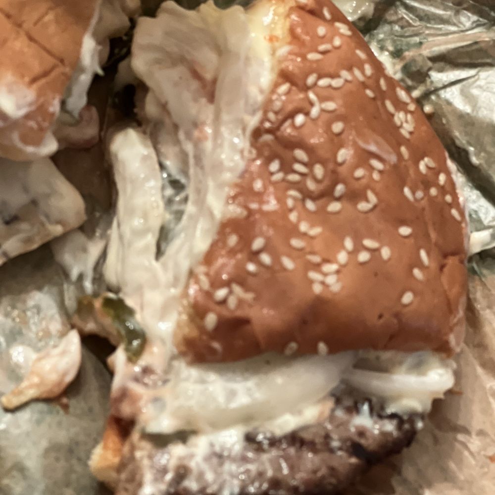 Burger King - a half eaten sandwich on a piece of tin foil - Burgers Near Me - Madison, Georgia