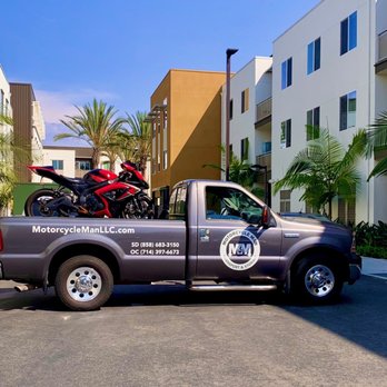 Motorcycle Man Transport & Storage - Motorcycle safely loaded with an electric lift and secured for transport. - Towing Near Me Motorcycle Man Transport & Storage - Motorcycle safely loaded with an electric lift and secured for transport. - Towing Near Me