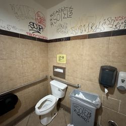 Noodle World - Odd restroom/bathroom, is the graffiti an intentional urban street decor by design or vandalism?