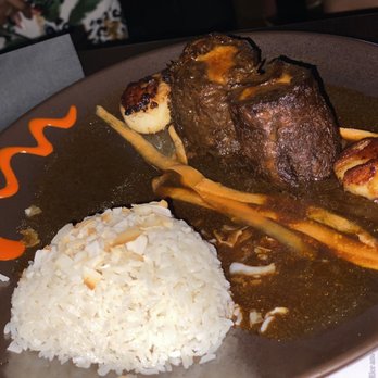 NK Restaurant - Surf (2 scallops) and turf braised oxtail (stuffed with potato and parsnip) w/ side of rice - Caribbean Near Me - East Meadow, New York NK Restaurant - Surf (2 scallops) and turf braised oxtail (stuffed with potato and parsnip) w/ side of rice - Caribbean Near Me - East Meadow, New York