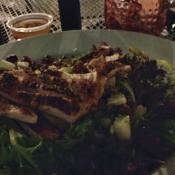 Brunzies - Four seasons salad with chicken, blue cheese, cranberries, and apples and a blueberry mule on a late patio. So good