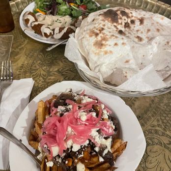 Zaytoons - a plate of nachos and a bowl of salad - Middle Eastern Near Me - Brooklyn, New York