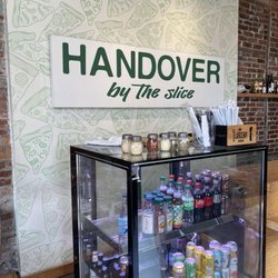 Handover by the Slice - Various drinks available. Rather a plain pizza shop. Signage here is the sole decor.
