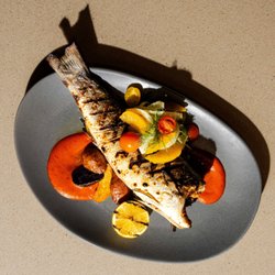 Laguna Restaurant & Bar - Mussels in white wine broth, wood-fired flatbread, whole grilled branzino, bold flavor, sun on the table, and plates made for sharing.