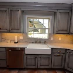 Hunter Kitchen & Bath - Distressed blue-gray cabinetry w/ a glaze. Full-height marble backsplash matching the countertop. Fun kitchen!