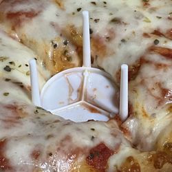 Stella’s Pizzeria 3 - They put the lid stand upside down so the flat part squished the pizza.