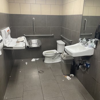 7-Eleven - a bathroom with a toilet, sink, mirror and trash can - Convenience Stores Near Me - Portland, Oregon