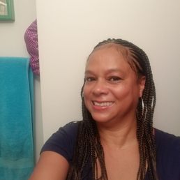 Cornrolls on top. Individuals in back.
