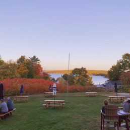 a group of people sitting at picnic tables