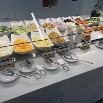 Air Canada Maple Leaf Lounge - Deluxe cold table section housing salad bar and slider style sandwich selections - Airport Lounges Near Me Air Canada Maple Leaf Lounge - Deluxe cold table section housing salad bar and slider style sandwich selections - Airport Lounges Near Me