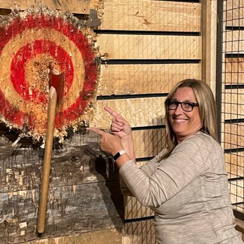 Timber Lounge Axe Throwing - a woman pointing at a target - Lounges Near Me - Dartmouth, Nova Scotia Timber Lounge Axe Throwing - a woman pointing at a target - Lounges Near Me - Dartmouth, Nova Scotia