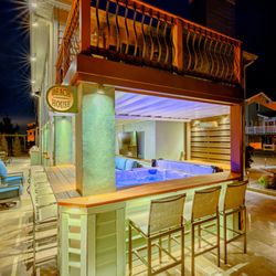 Outdoor patio with custom beach bar and hot tub