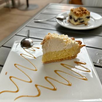 Cup Cafe - a piece of cake on a plate with caramel drizzle - New American Near Me - Tucson, Arizona