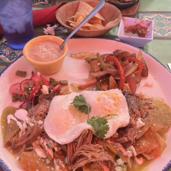 Felipe's - Chilaquiles with carnitas added and trio fajitas in back - Mexican Near Me - Palm Springs, California Felipe's - Chilaquiles with carnitas added and trio fajitas in back - Mexican Near Me - Palm Springs, California